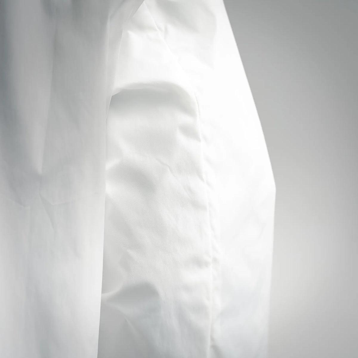 Moncler white coat sleeve and side panel seam close-up