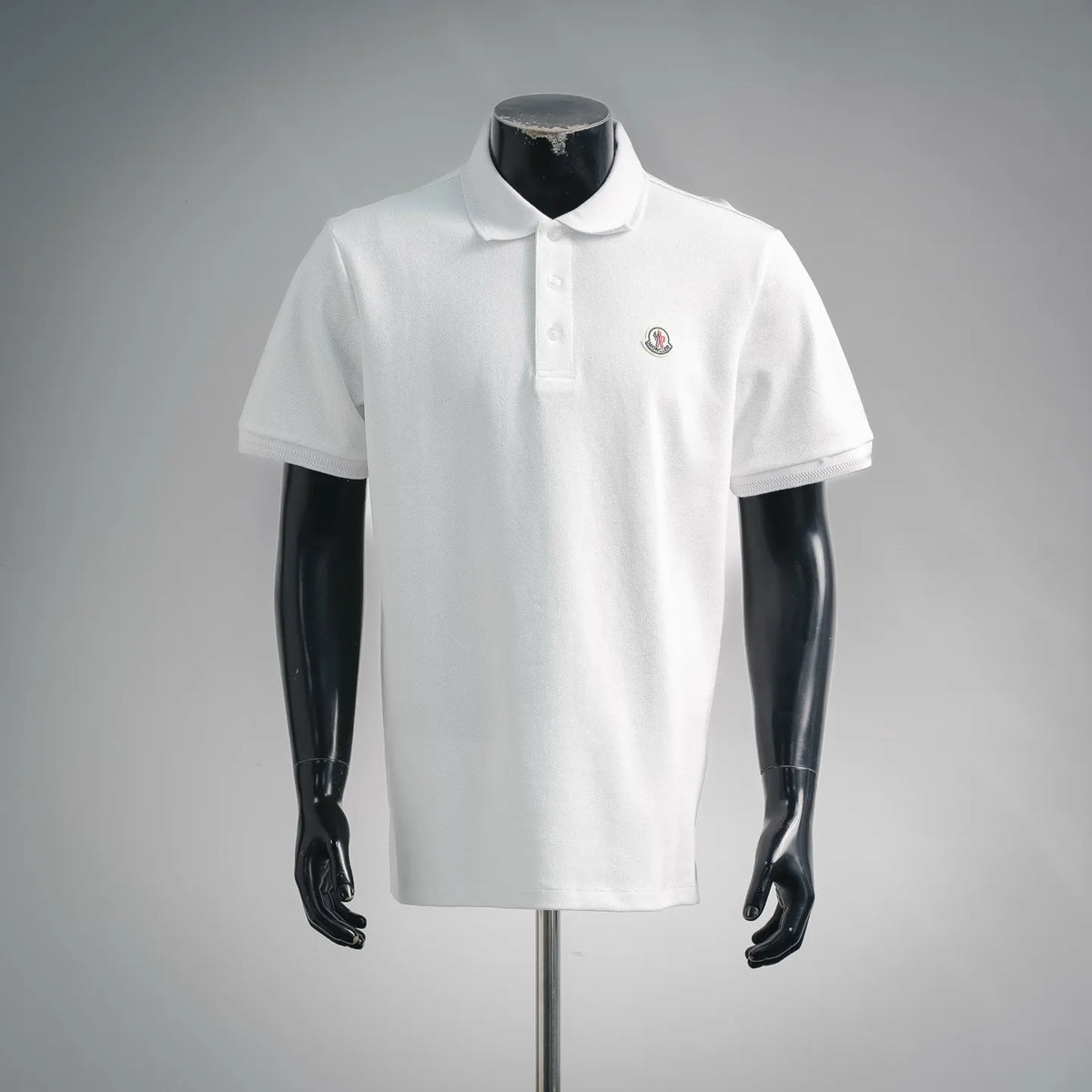 White polo shirt with button placket and small chest Moncler logo patch