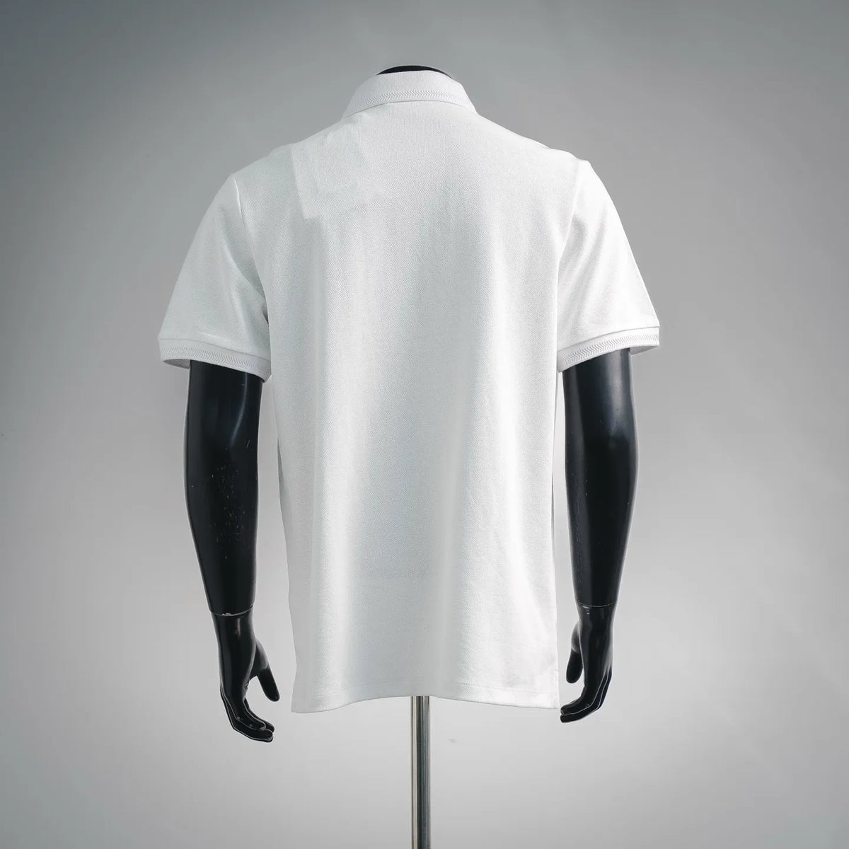 White polo shirt, back view with short sleeves and crew-style collar