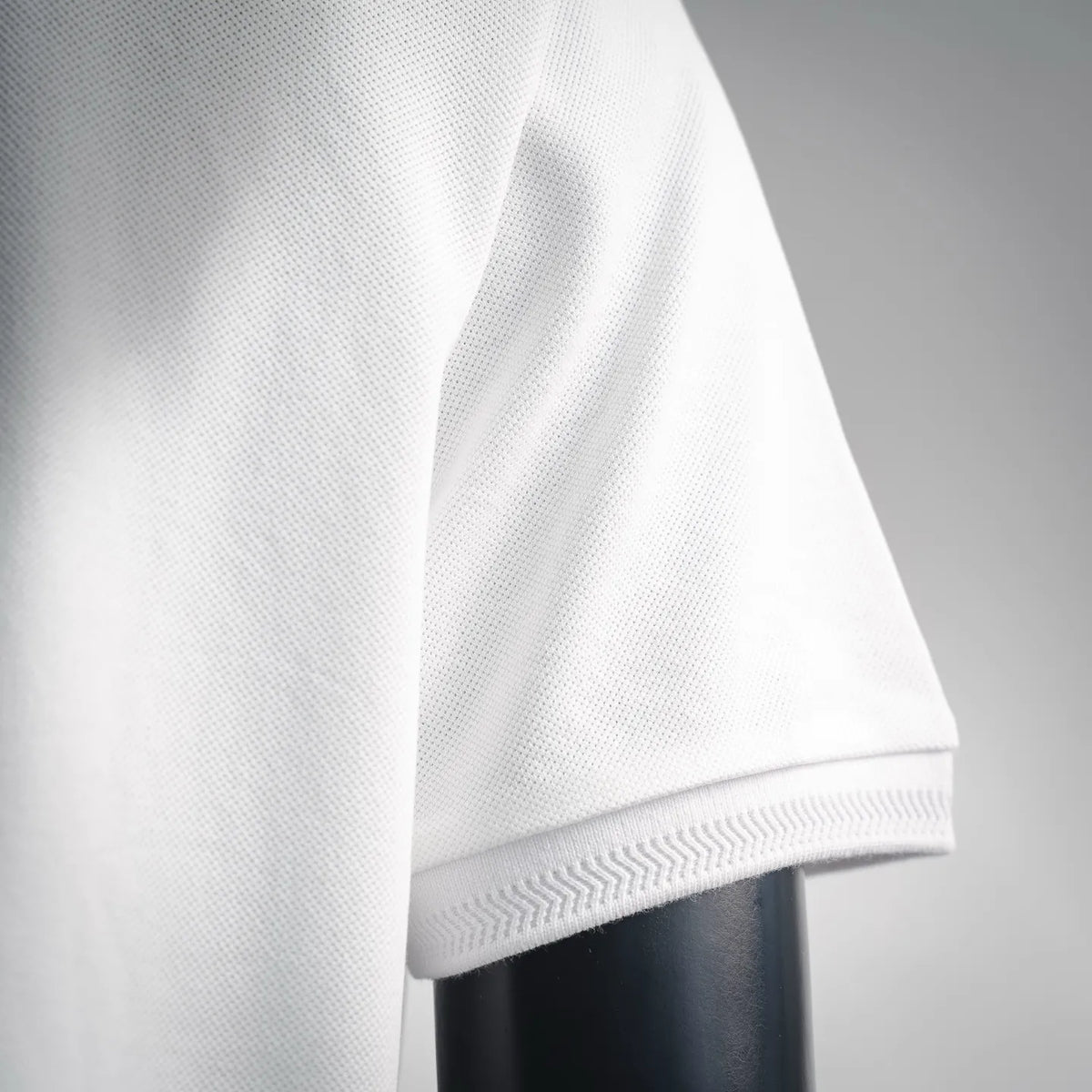 White polo sleeve hem with ribbed cuff trim