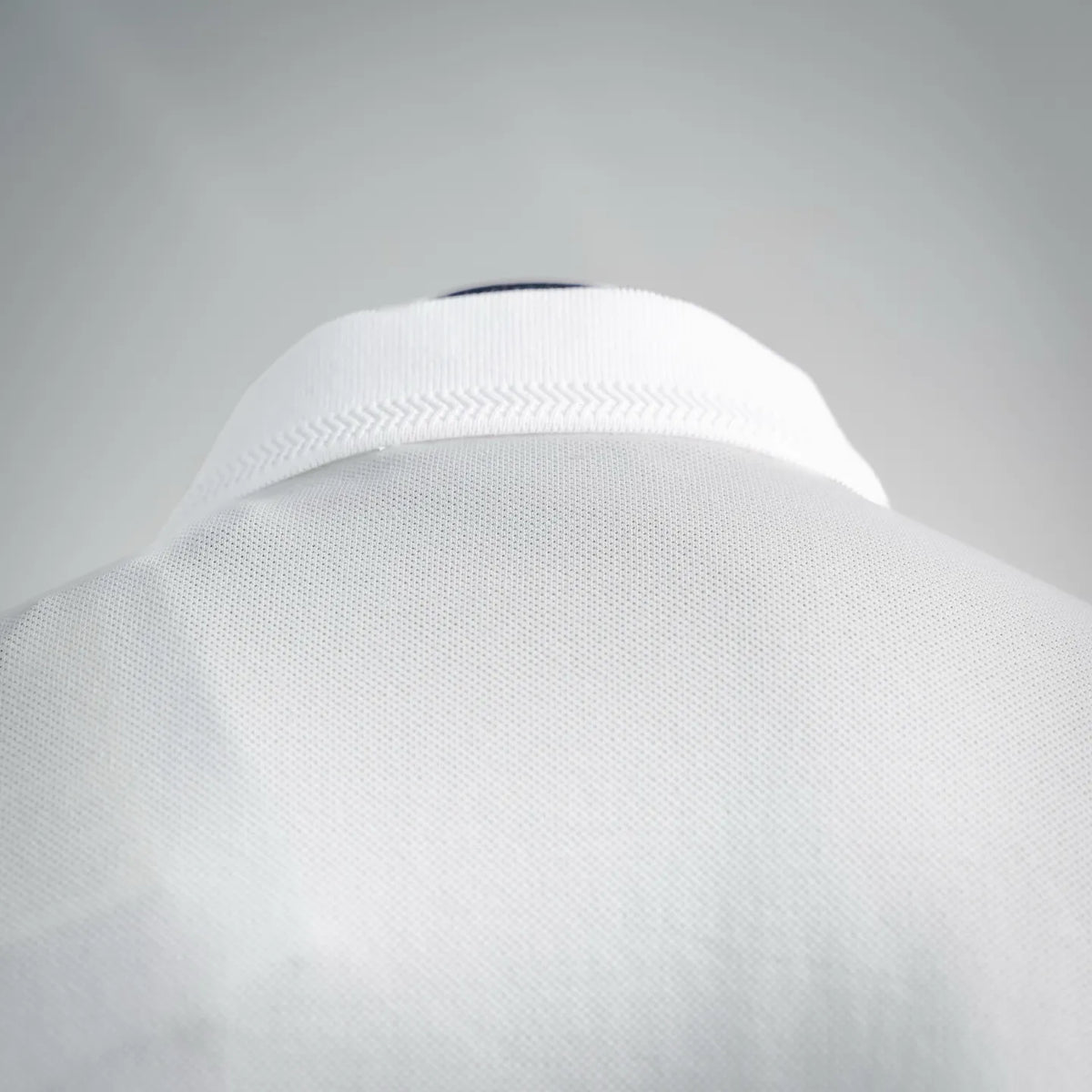 White polo collar and shoulder seam detail with textured knit
