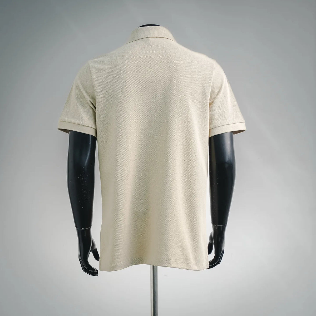 Cream polo shirt back view with short sleeves and curved collar