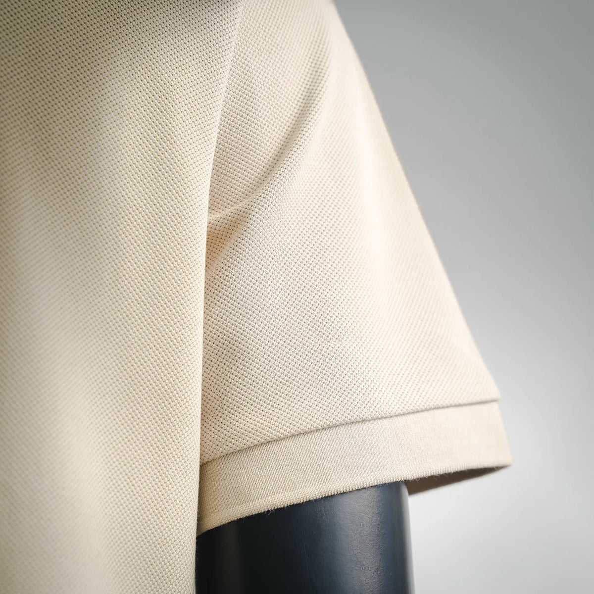 Cream short-sleeve polo hem with ribbed cuff detail