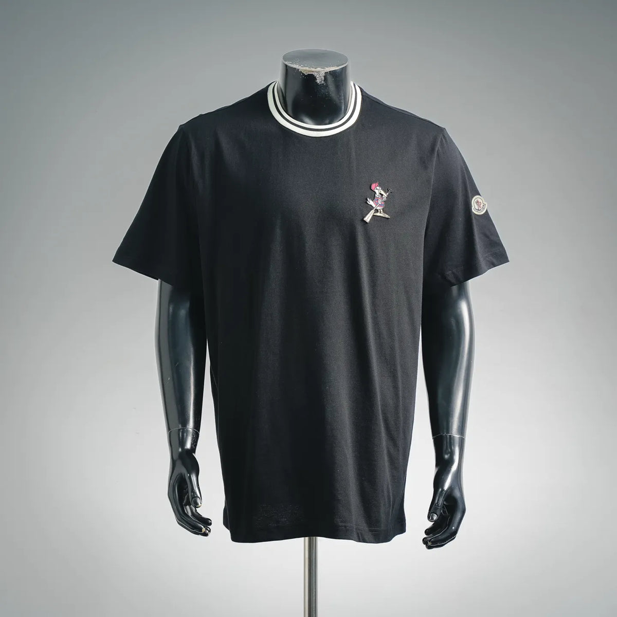 Black short-sleeve T-shirt with cartoon chest patch and round Moncler sleeve logo