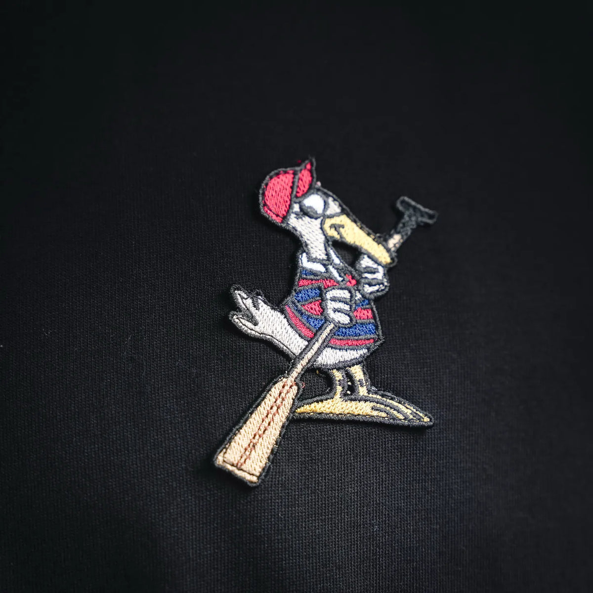 Embroidered cartoon patch on black T-shirt chest