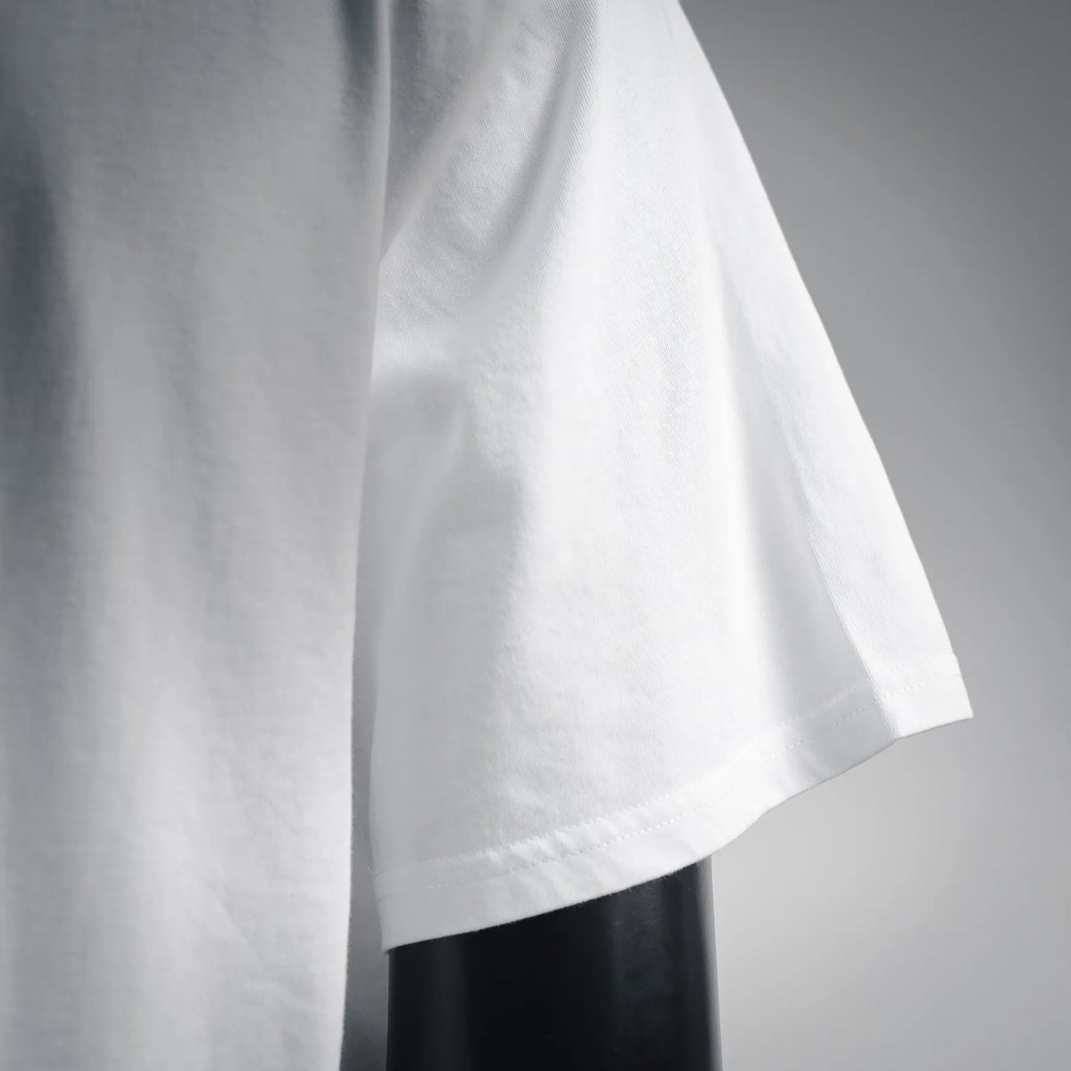 White crew-neck T-shirt fabric and hem close-up