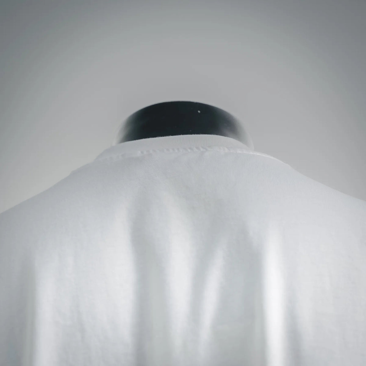 White T-shirt back neckline and shoulder seam close-up