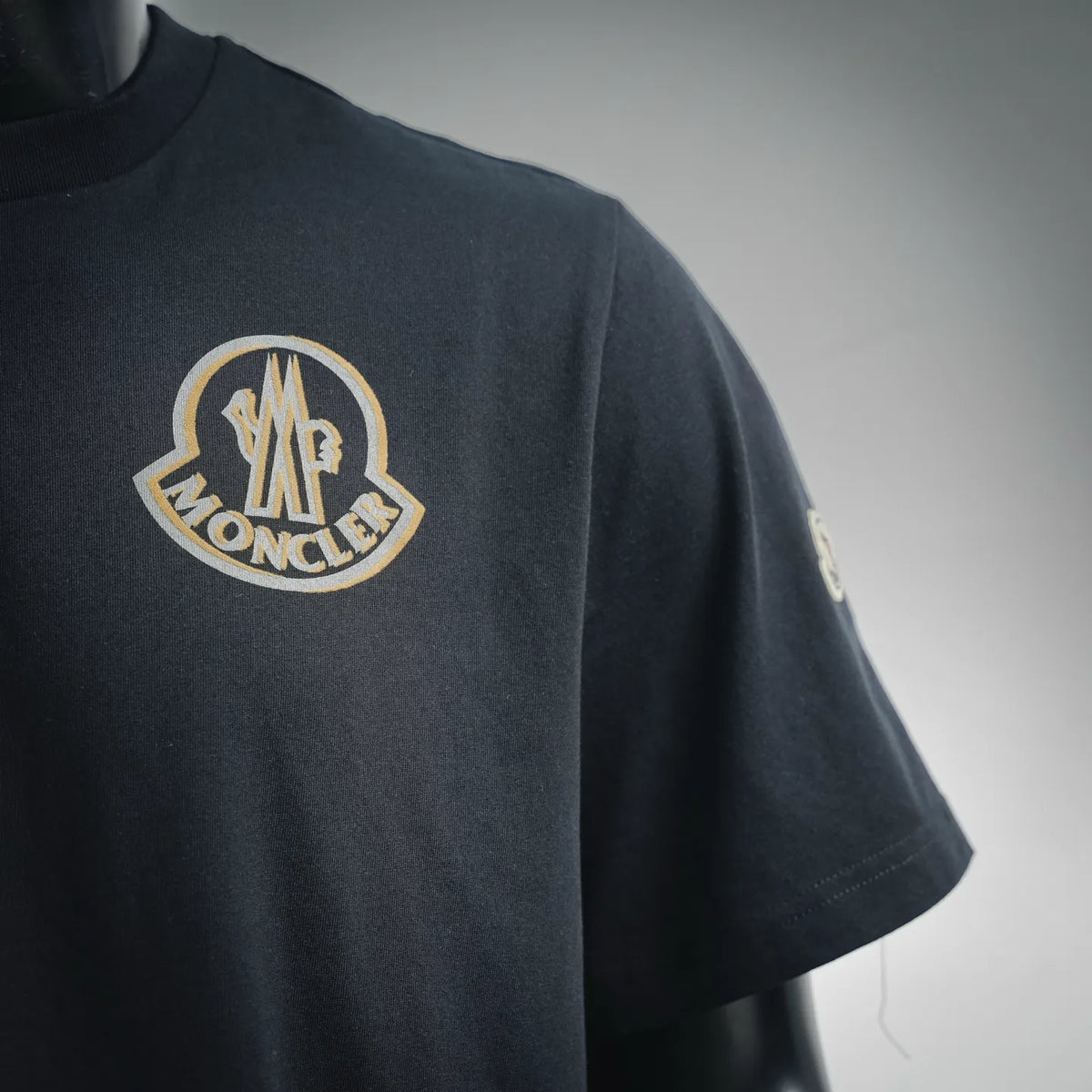Black Moncler short-sleeve T-shirt with gold-and-white chest logo