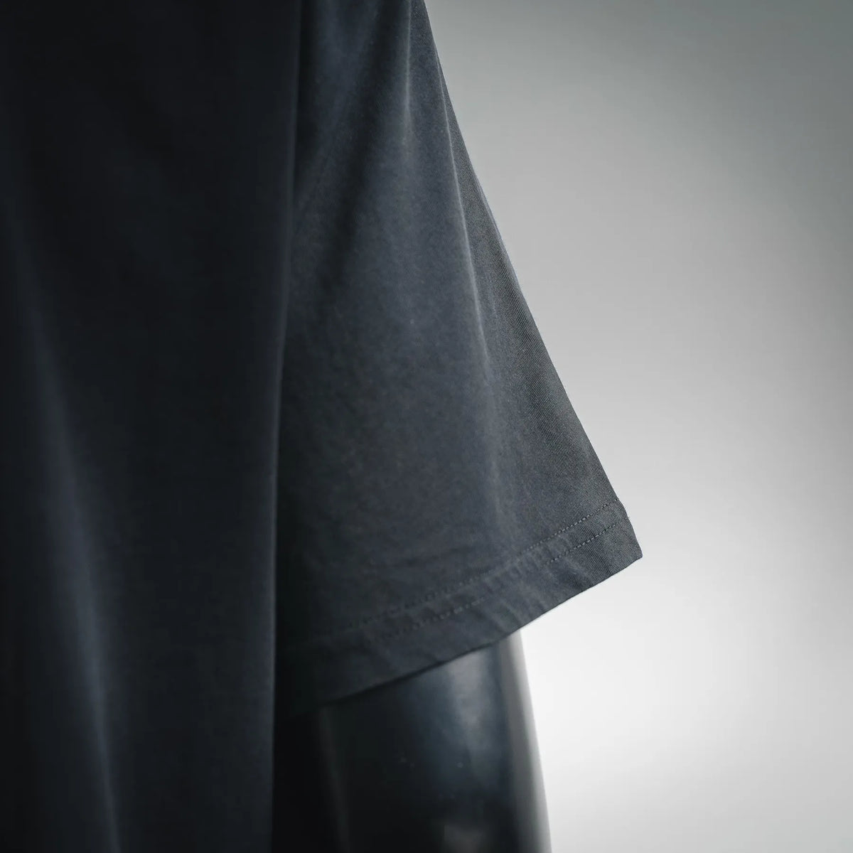 Black Moncler T-shirt side seam and curved hem