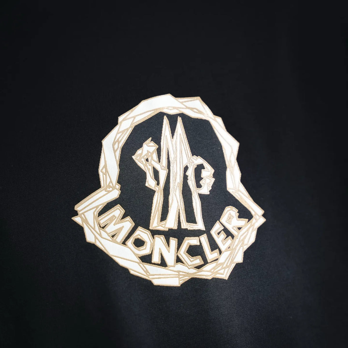 Black Moncler T-shirt with large white crest-style front graphic