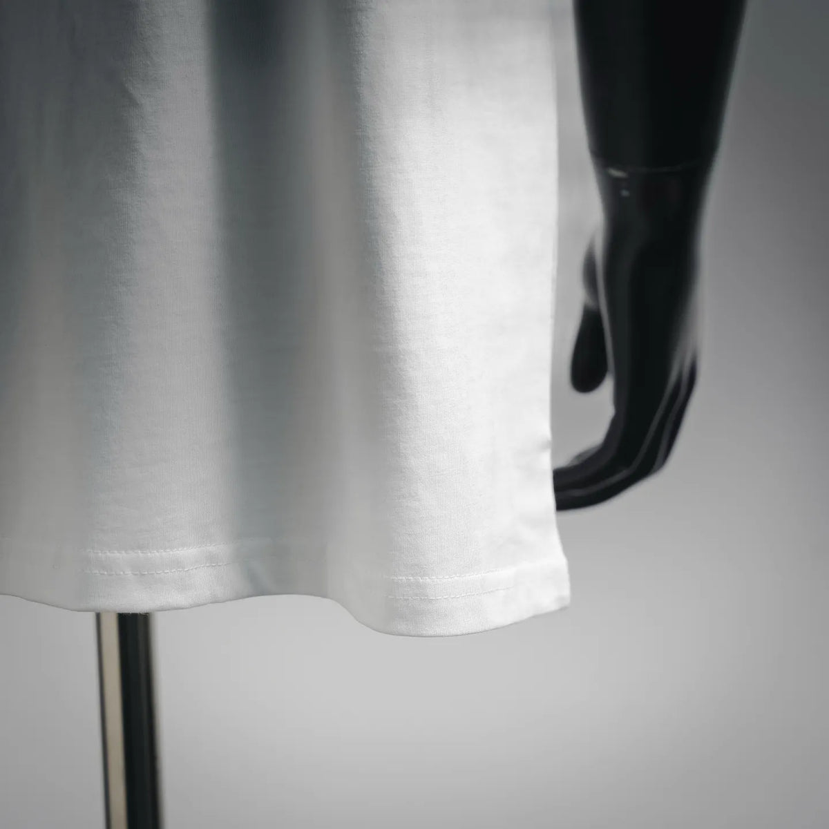 White short-sleeve T-shirt hem with visible seam detail