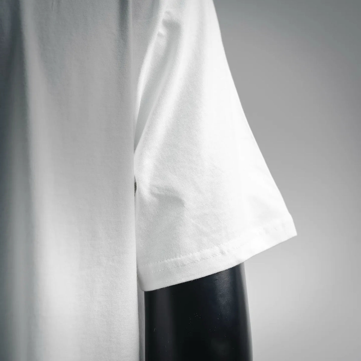 White short-sleeve T-shirt sleeve and side seam close-up