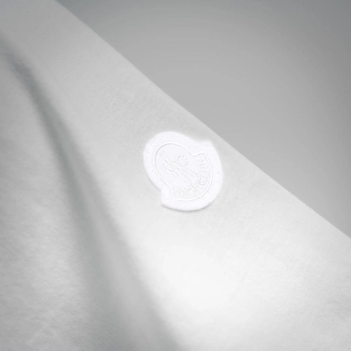 White T-shirt fabric with raised Moncler logo stamp detail