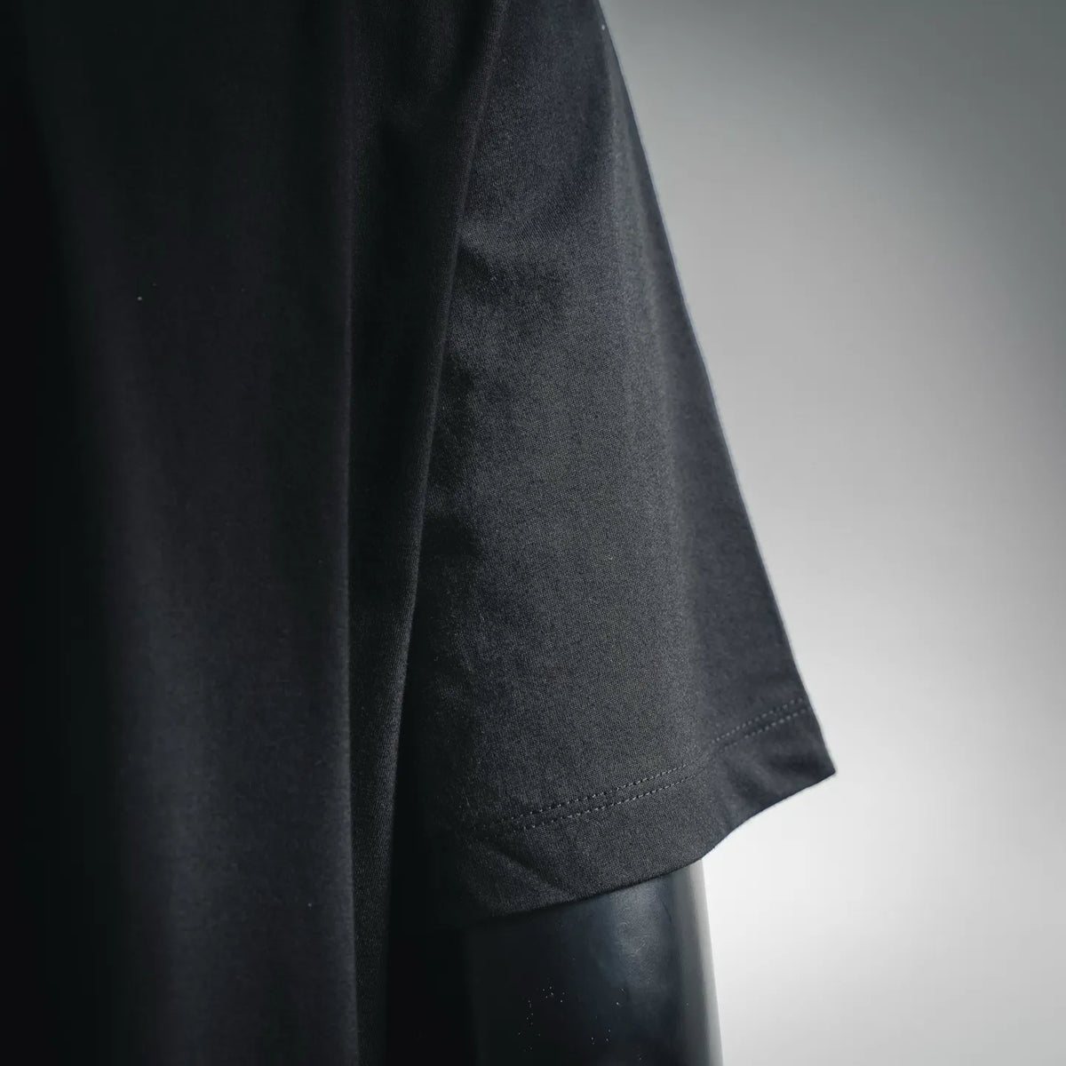 Dark short-sleeve mock-neck T-shirt sleeve with stitched hem detail