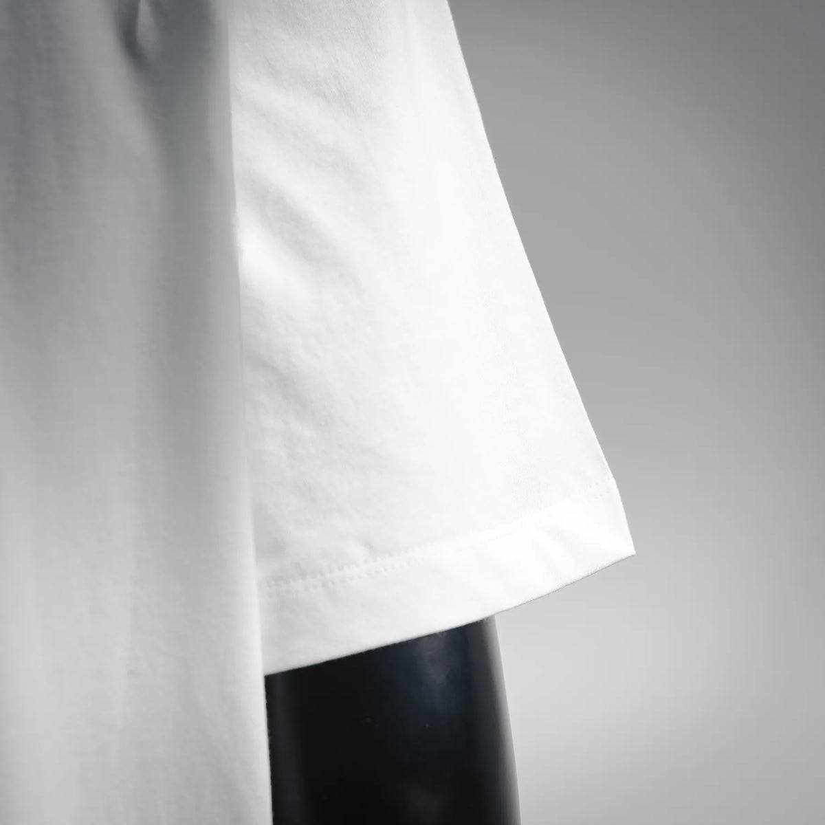 White T-shirt hem with straight cut and stitched edge