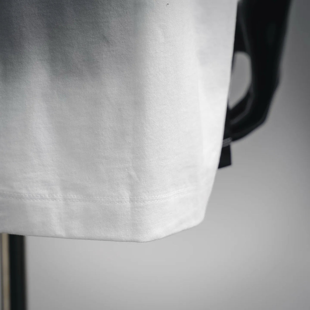 White crewneck T-shirt sleeve hem seam detail