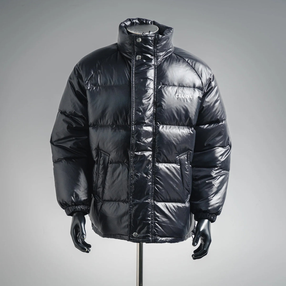 Men's black puffer coat with stand collar, front zipper, and side pockets