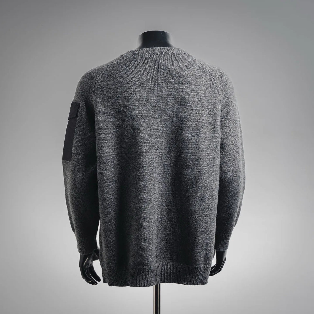 Gray heather long-sleeve knit sweater with crew neck and sleeve logo patch detail on the back