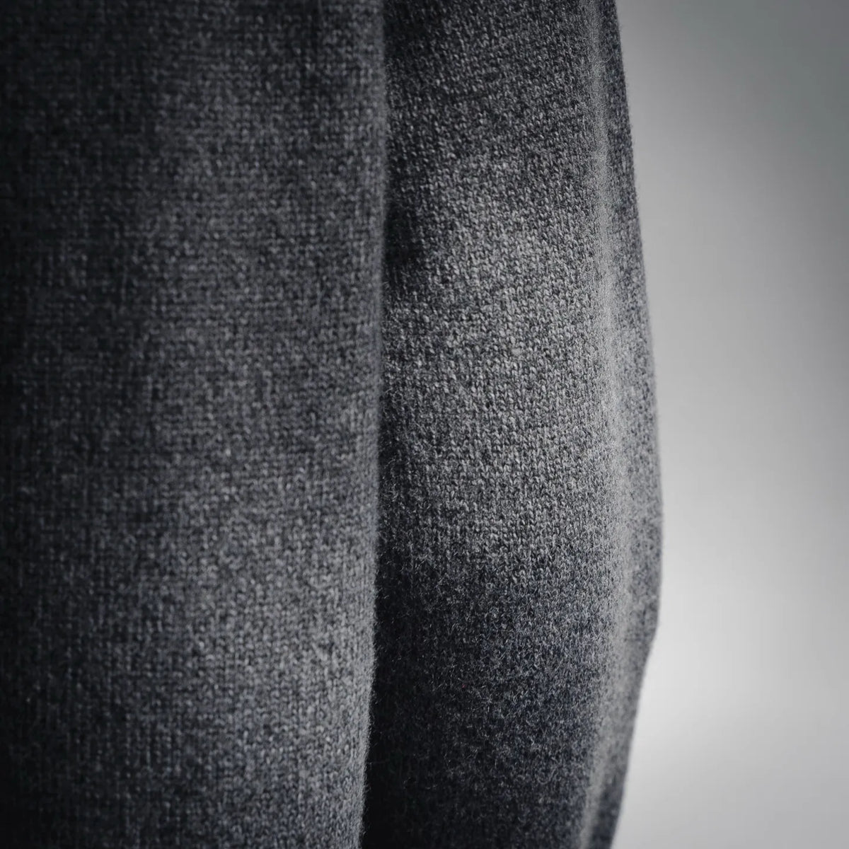 Gray heather knit fabric panel close-up on a long-sleeve sweater