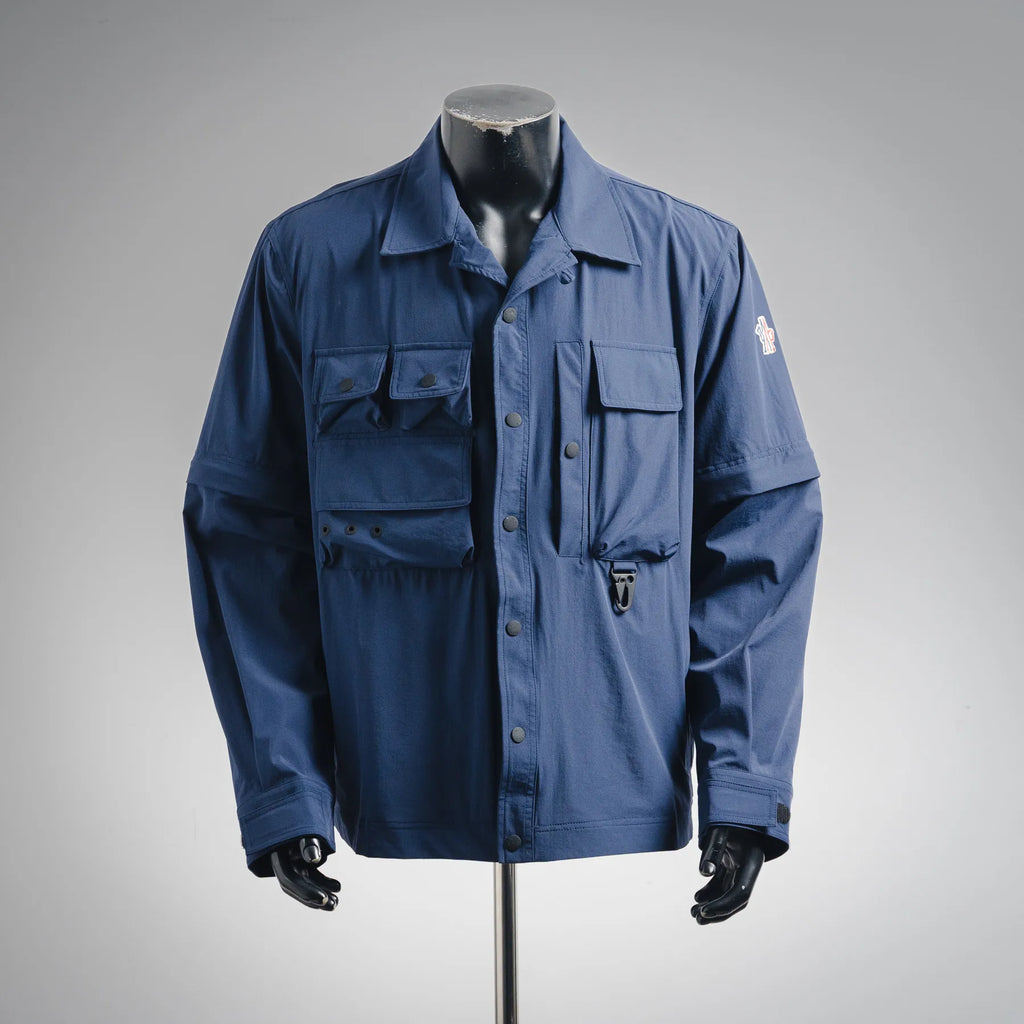 Blue long-sleeve jacket with button front and flap chest pockets