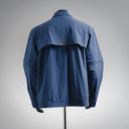 Blue long-sleeve jacket back with yoke seams and patch pocket