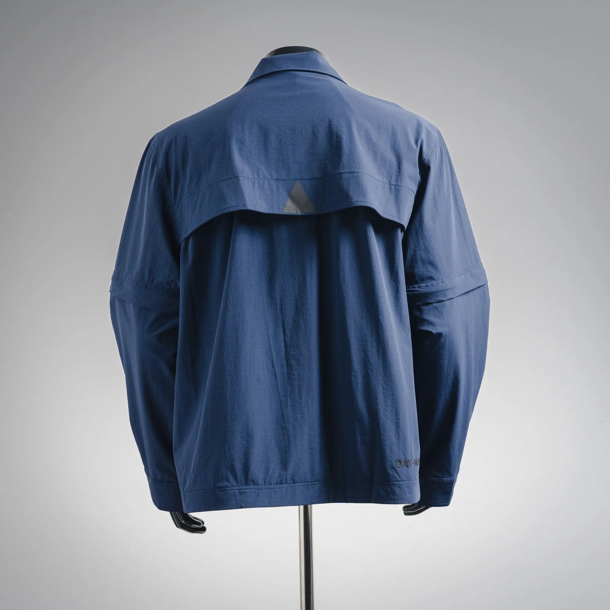 Blue long-sleeve jacket back with yoke seams and patch pocket