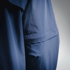 Blue jacket fabric close-up with seam stitching and slight fold
