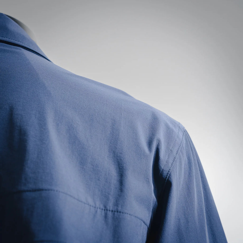 Blue jacket shoulder and upper back panel with subtle texture
