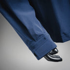 Blue jacket sleeve with buttoned cuff and visible stitching