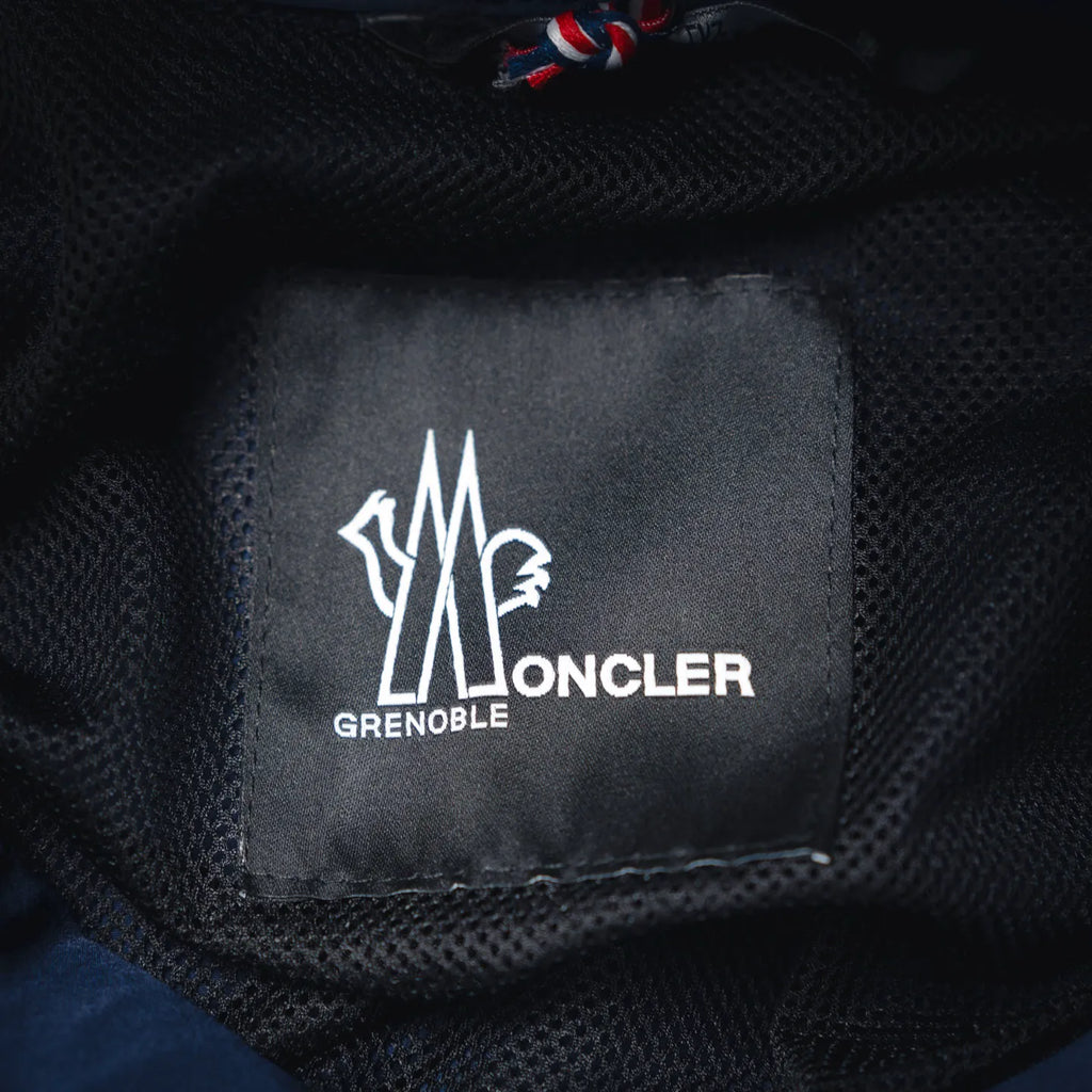 Moncler Grenoble logo label on dark inner fabric lining