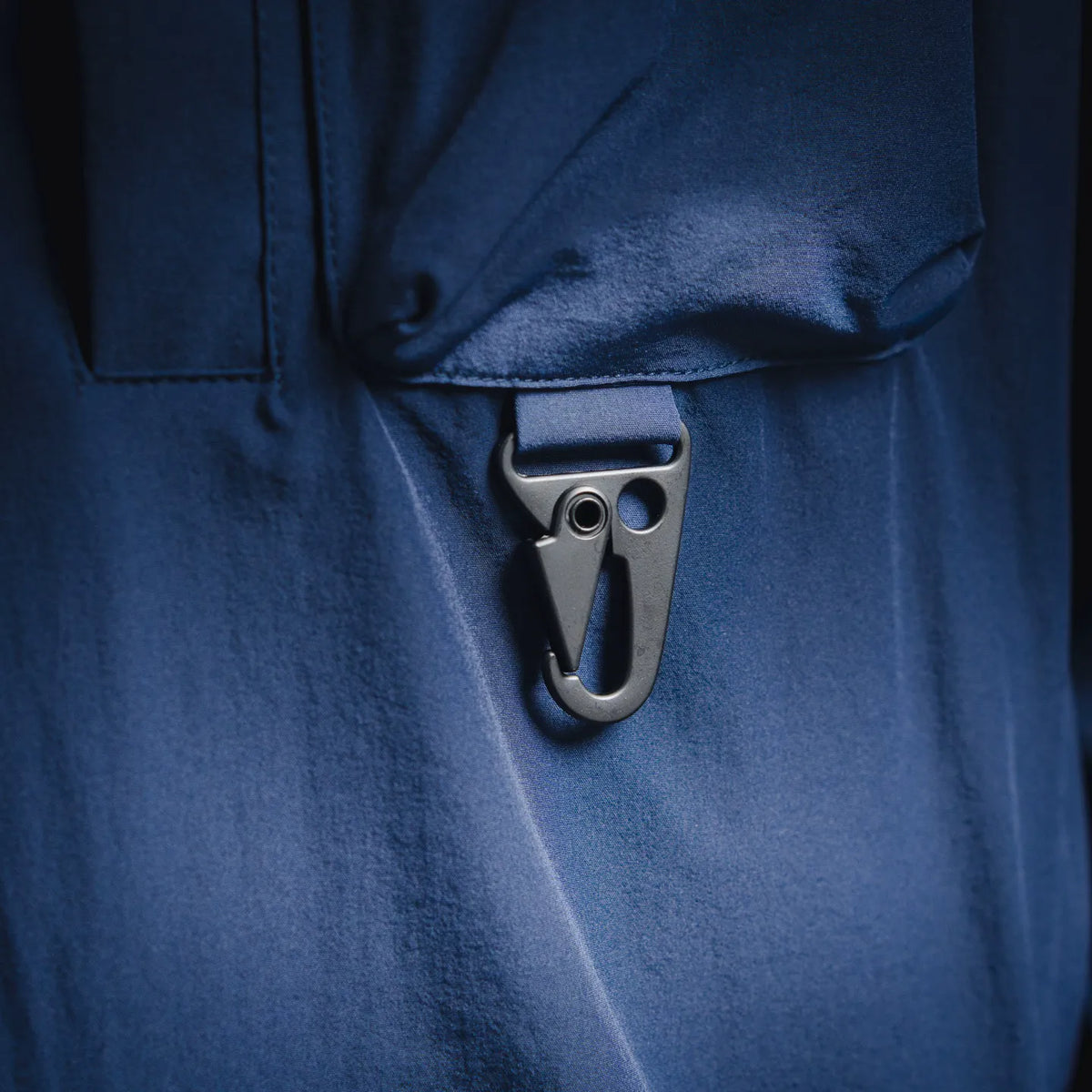 Blue jacket front with hook-and-loop strap and flap pocket