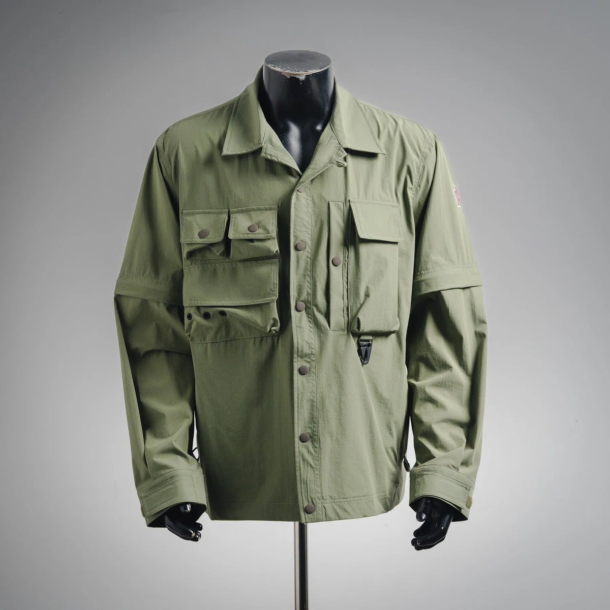 Olive long-sleeve jacket with snap pockets and button placket