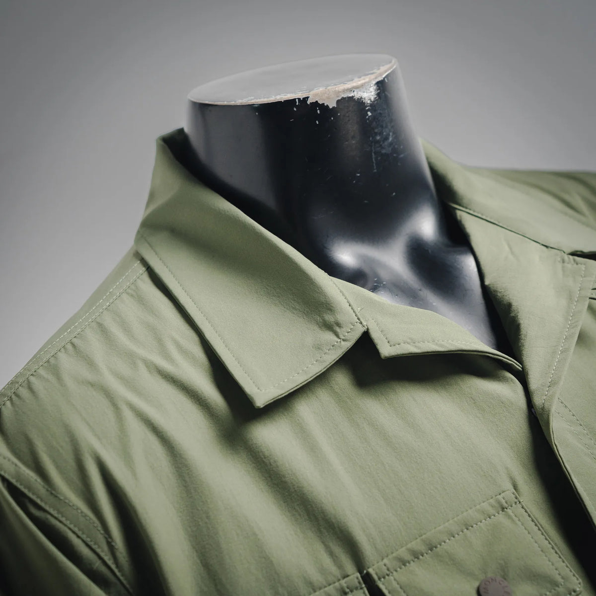 Olive jacket collar and front placket with snap buttons