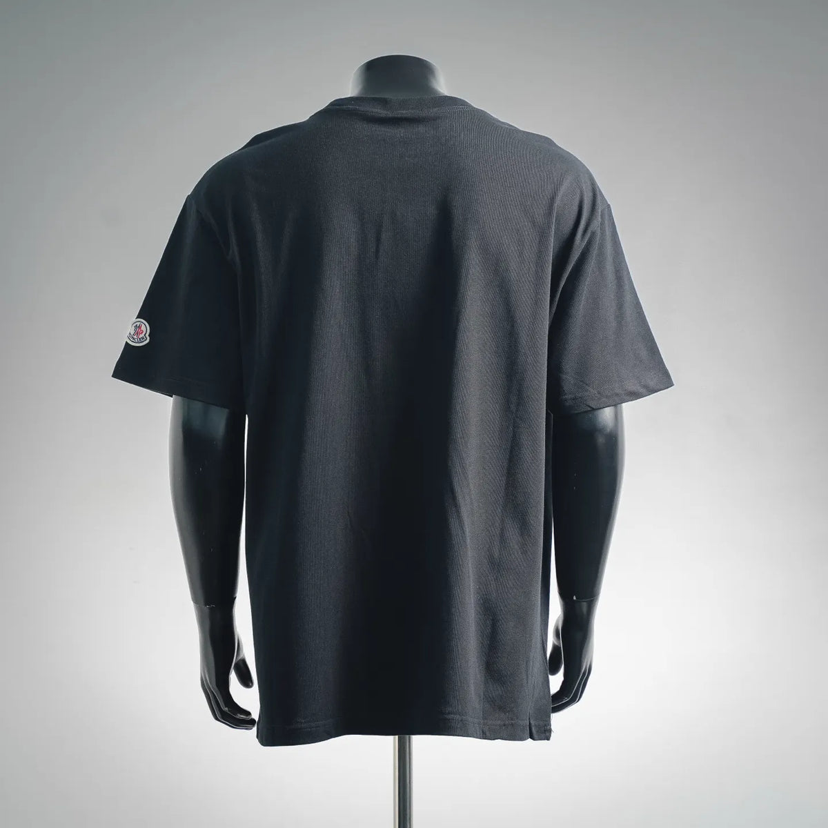 Men's Moncler black crew-neck T-shirt, back view with small sleeve logo