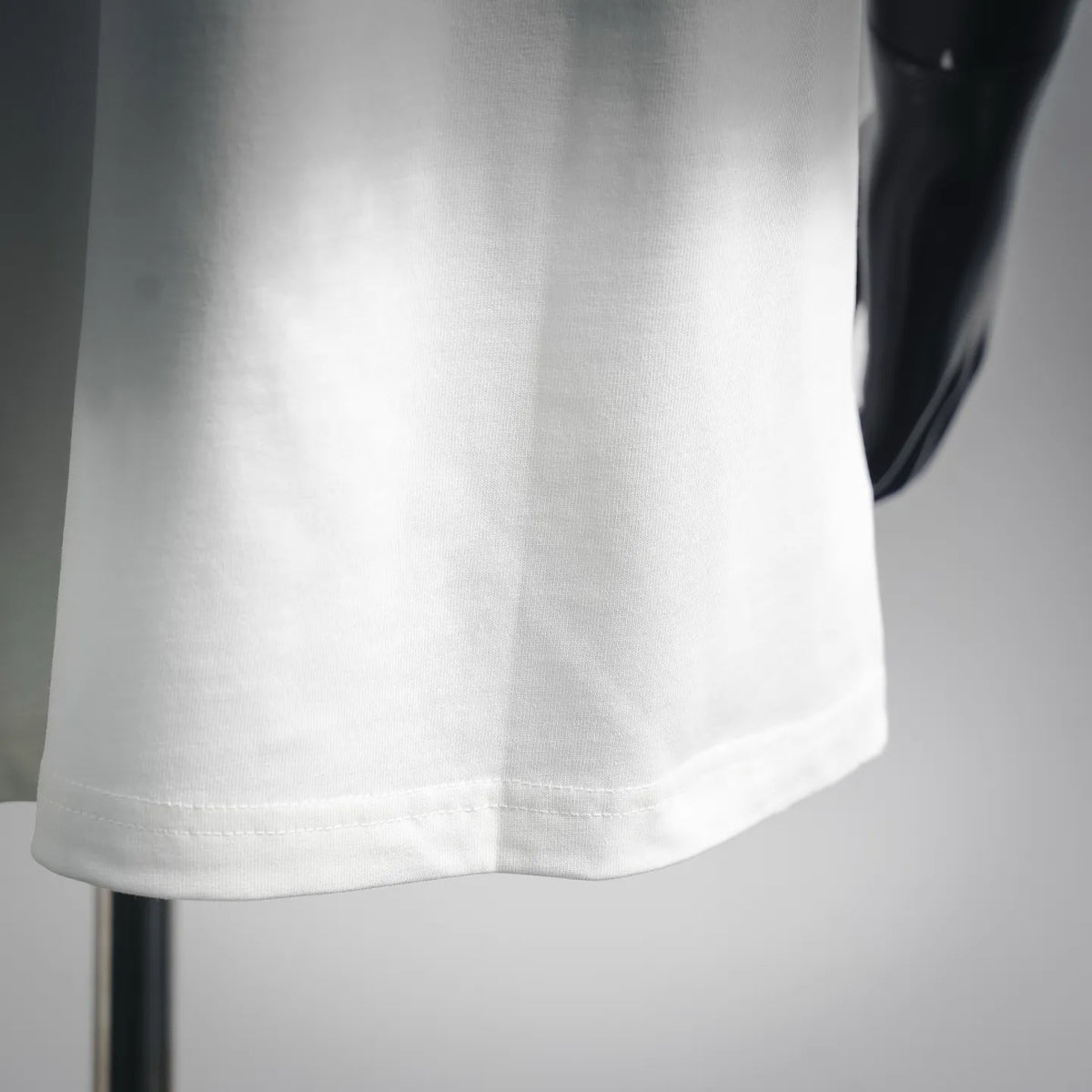 White T-shirt bottom hem with visible stitching