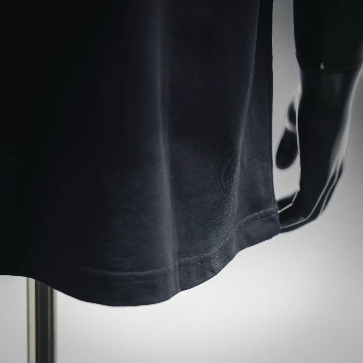 Dark navy short-sleeve T-shirt with visible hem and stitched side seam