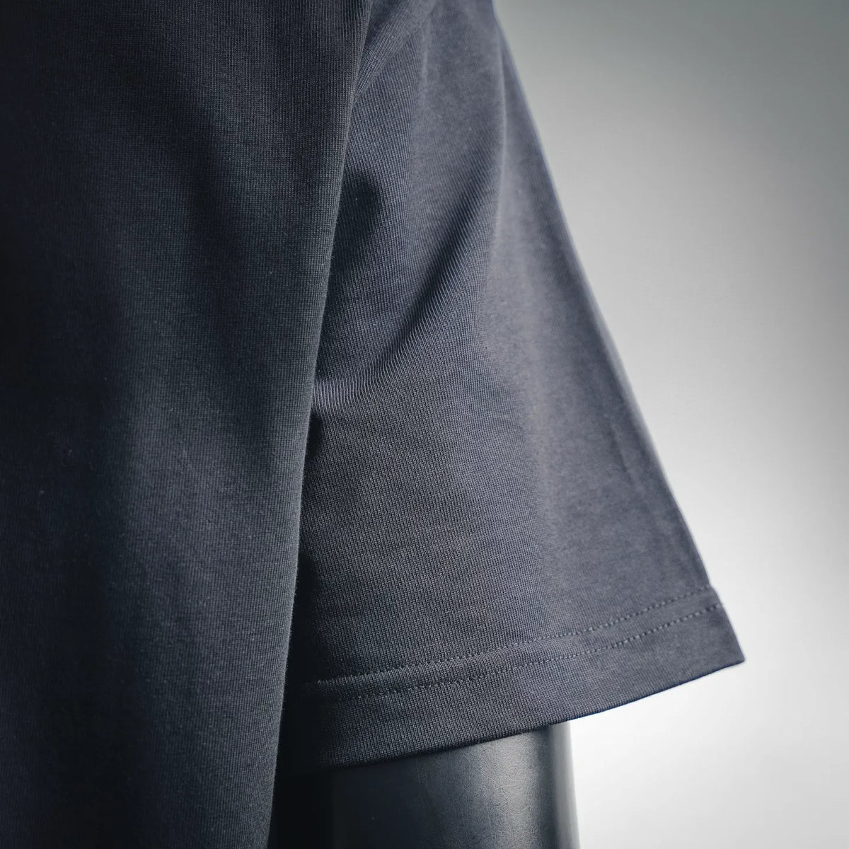 Dark navy short-sleeve T-shirt sleeve cuff with stitched hem edge