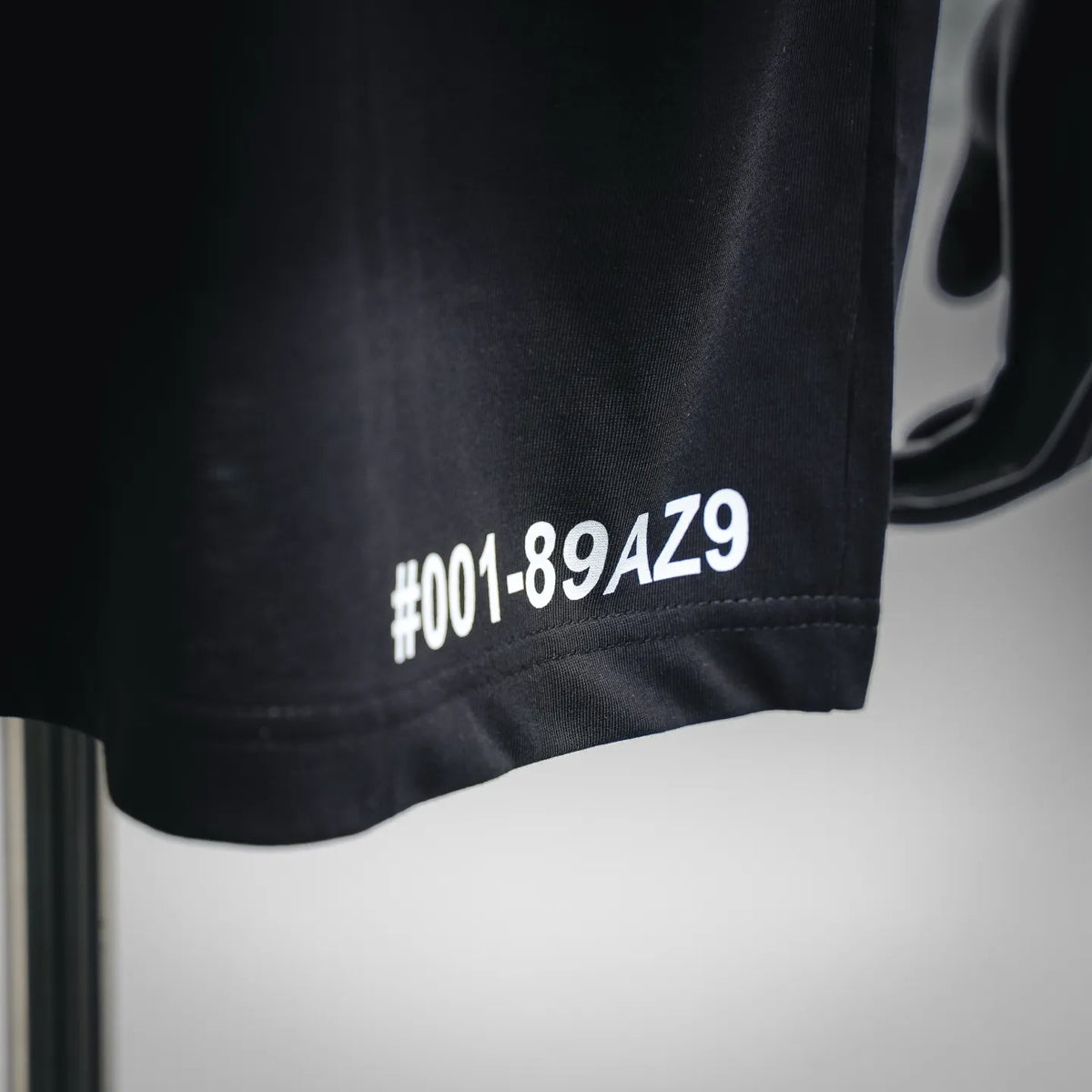 Black T-shirt hem with white #001-89AZ9 print