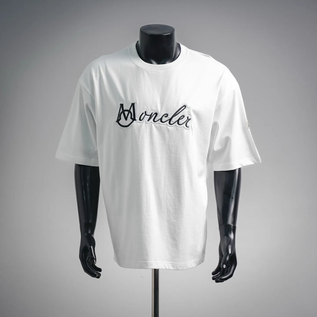 White Moncler short-sleeve T-shirt with black script logo on the chest
