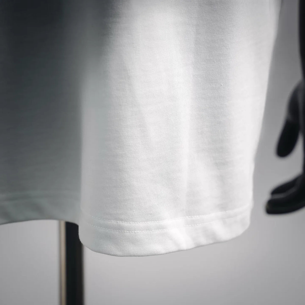 White Moncler short-sleeve T-shirt close-up of lower hem and seam