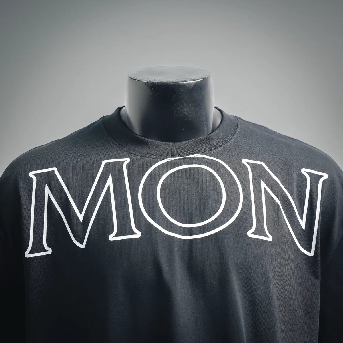 Black Moncler T-shirt with oversized MONCLER logo across the chest