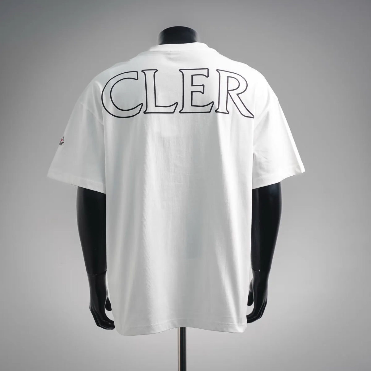 White Moncler short-sleeve T-shirt with CLER graphic print on the back.