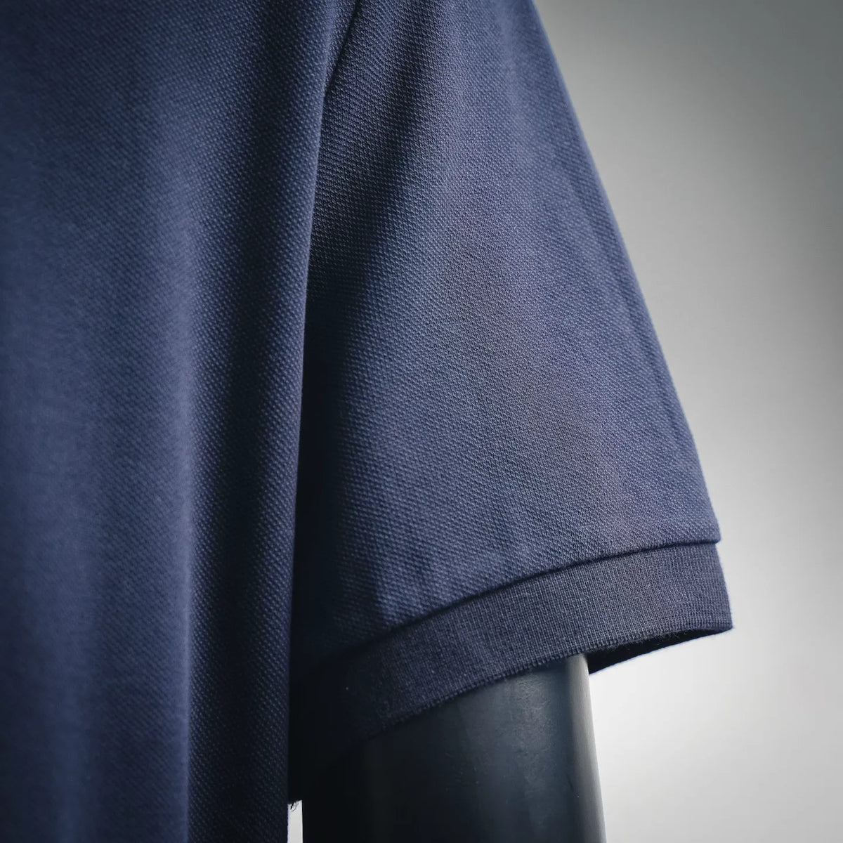 Moncler polo shirt sleeve and hem, textured navy knit fabric detail