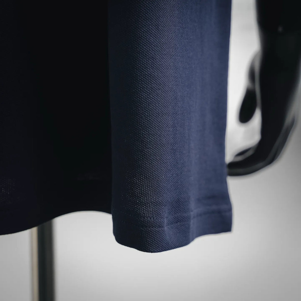 Moncler polo shirt hem and side seam, dark navy fabric