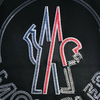 Moncler black T-shirt graphic close-up with blue, red, and white striped elements