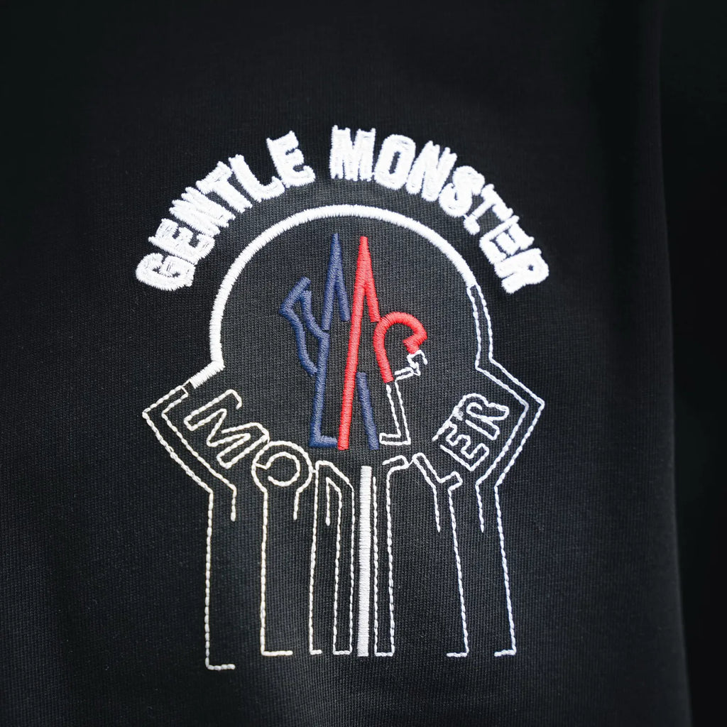 Moncler black T-shirt back close-up of crest graphic with arched lettering