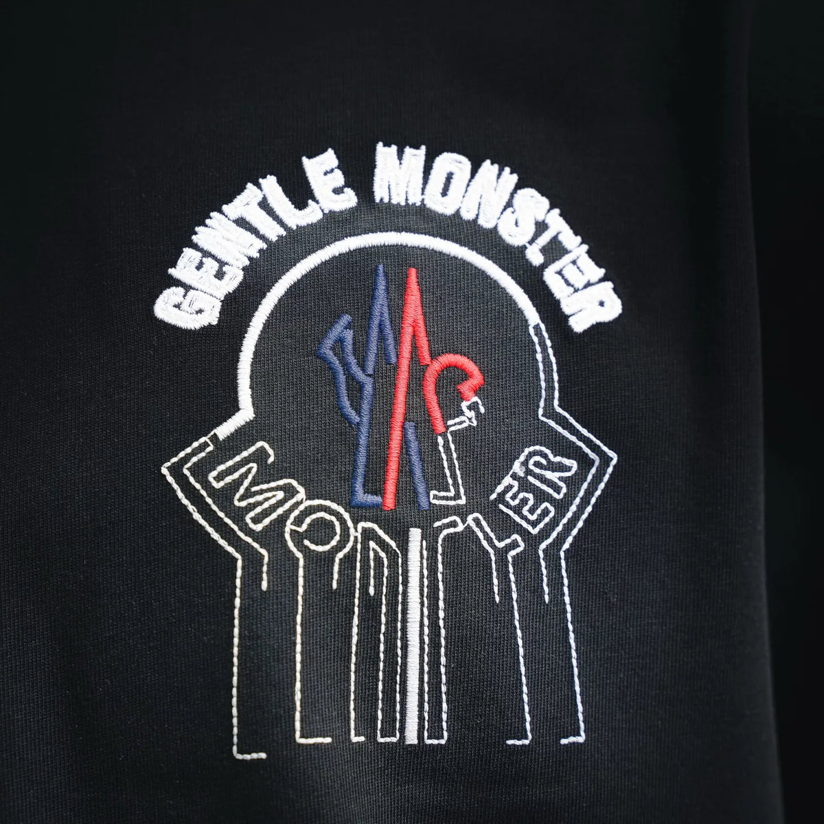 Moncler black T-shirt back close-up of crest graphic with arched lettering