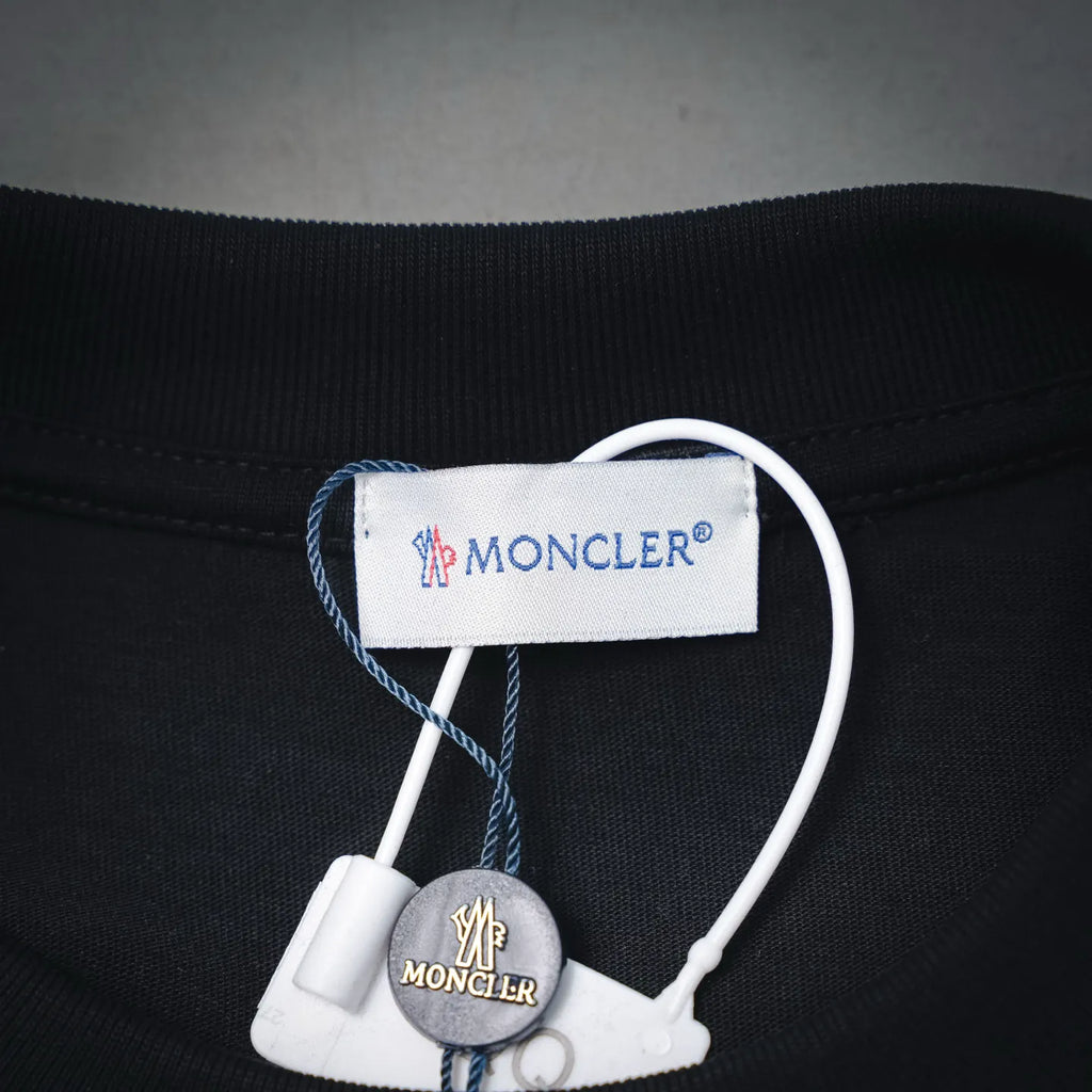 Moncler black T-shirt neck label and small hanging brand tag detail