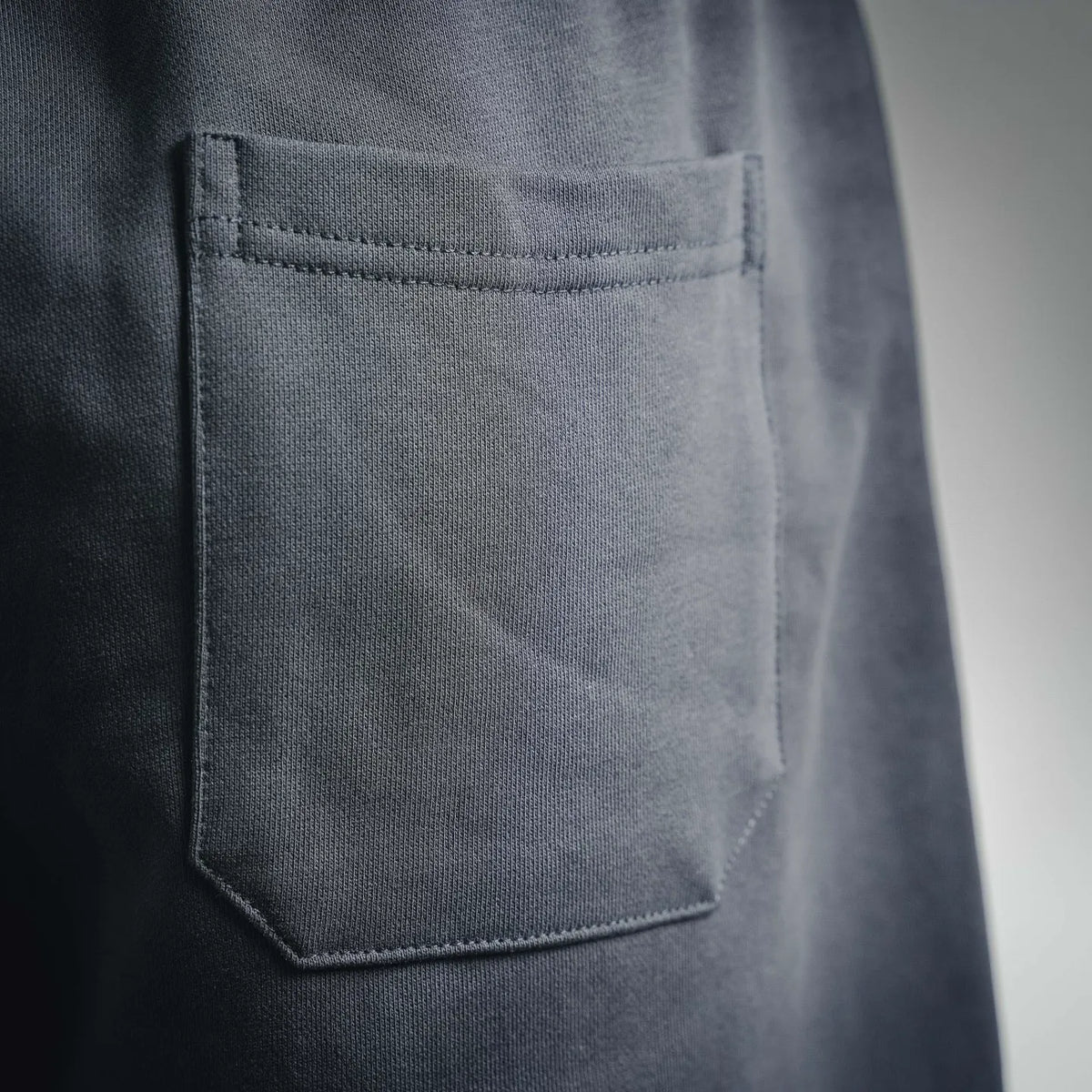 Off-White dark shorts front pocket detail with stitched edge