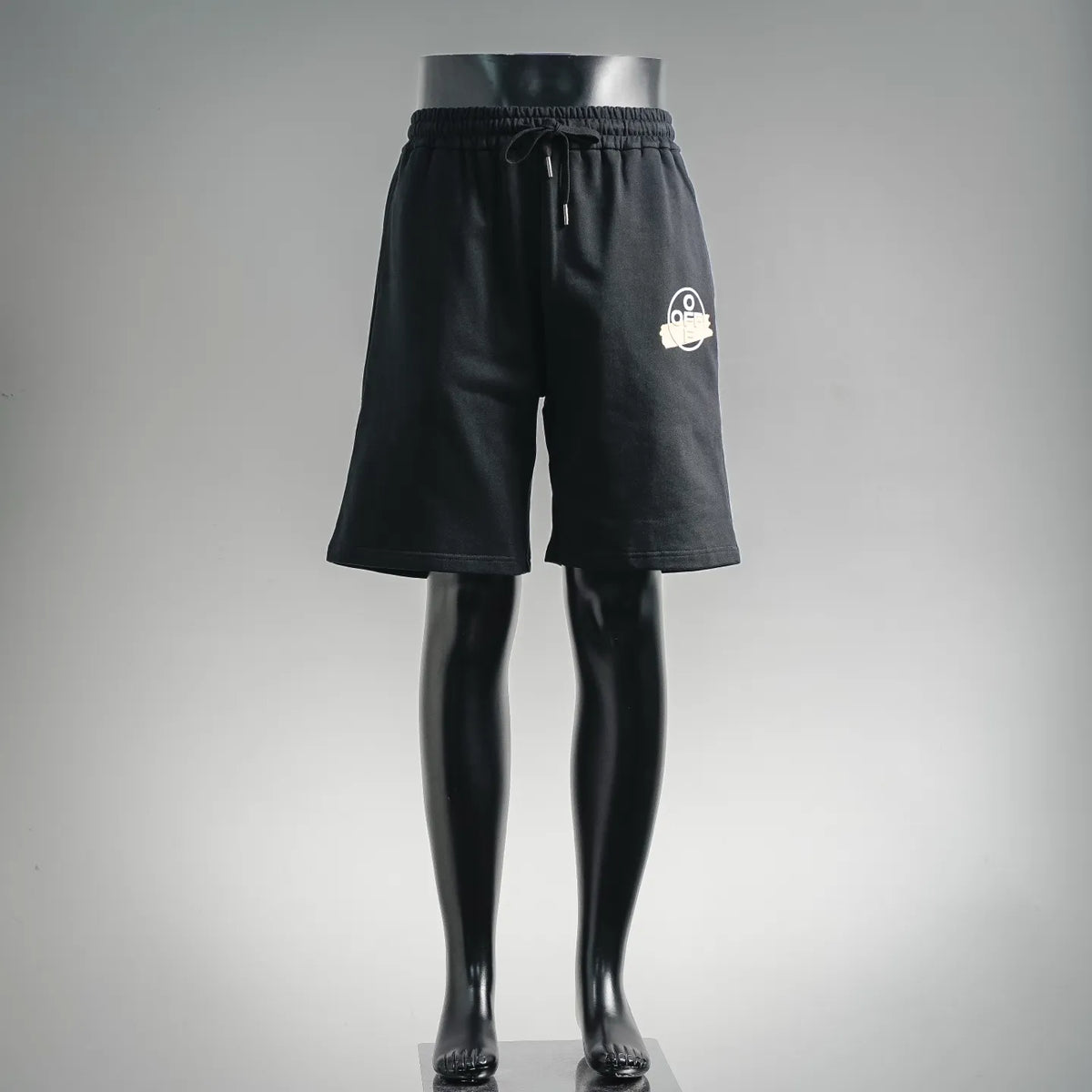 Dark drawstring shorts with elastic waist and small white logo on front